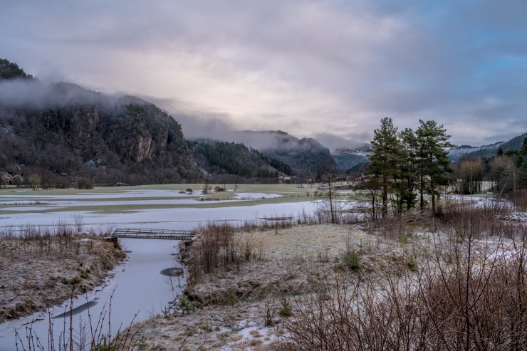 Winter landscape photo of fog floating on the mountains in Norway